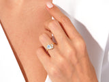 Gold ring with moonstone and diamonds on a woman's hand