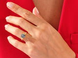 Gold ring with black gemstone and diamonds on a hand