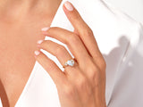 Gold ring with square gemstone and diamonds on a woman's hand
