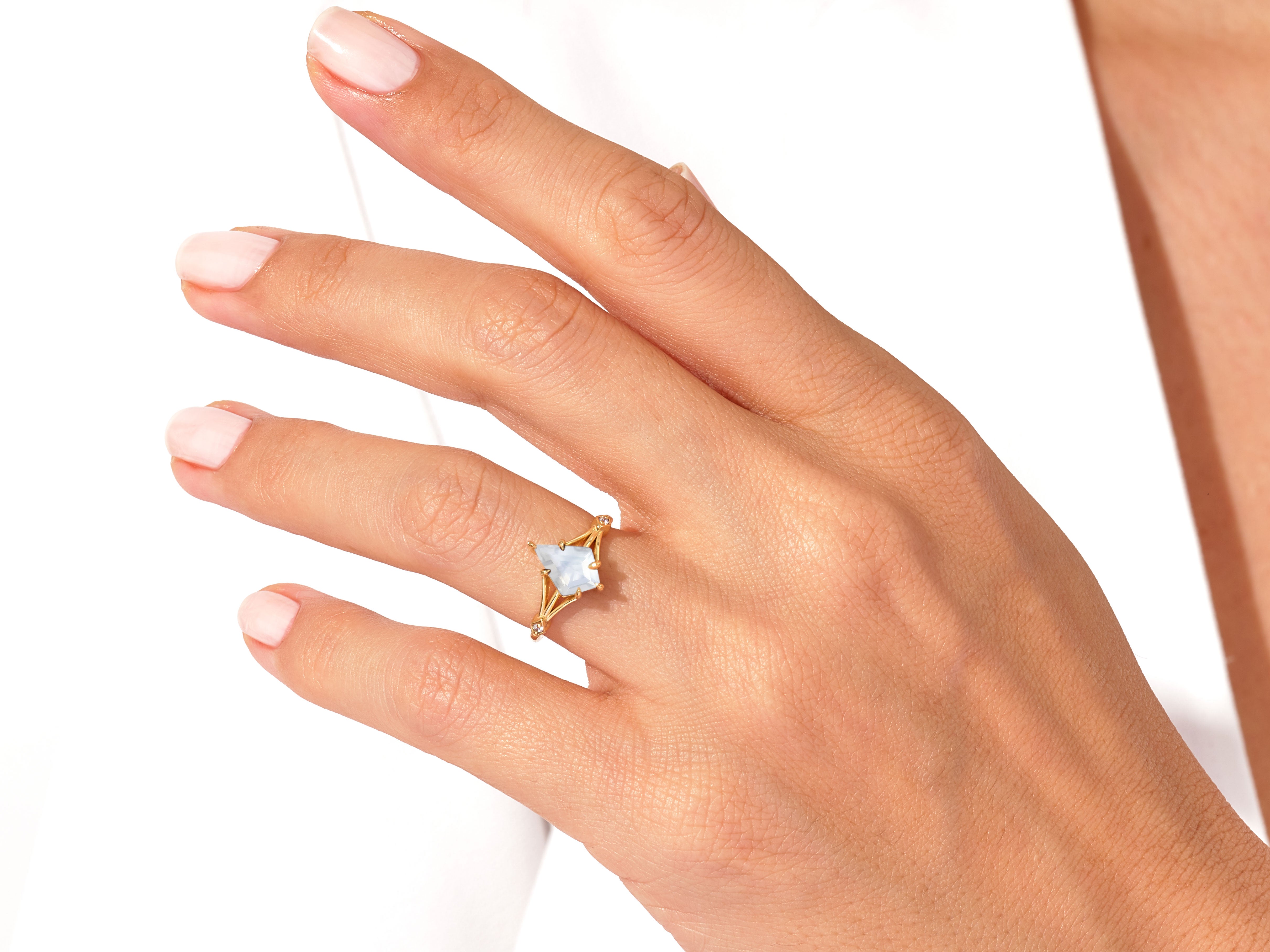 Gold ring with unique gemstone on hand