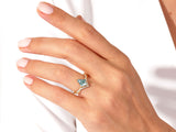 Gold ring with moss agate and diamonds on a hand
