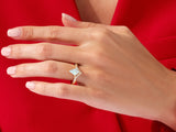 Gold diamond and opal ring on a woman's hand