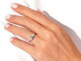 Gold ring with moss agate and diamonds on a hand