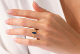 Gold ring with blue stone on a woman's finger