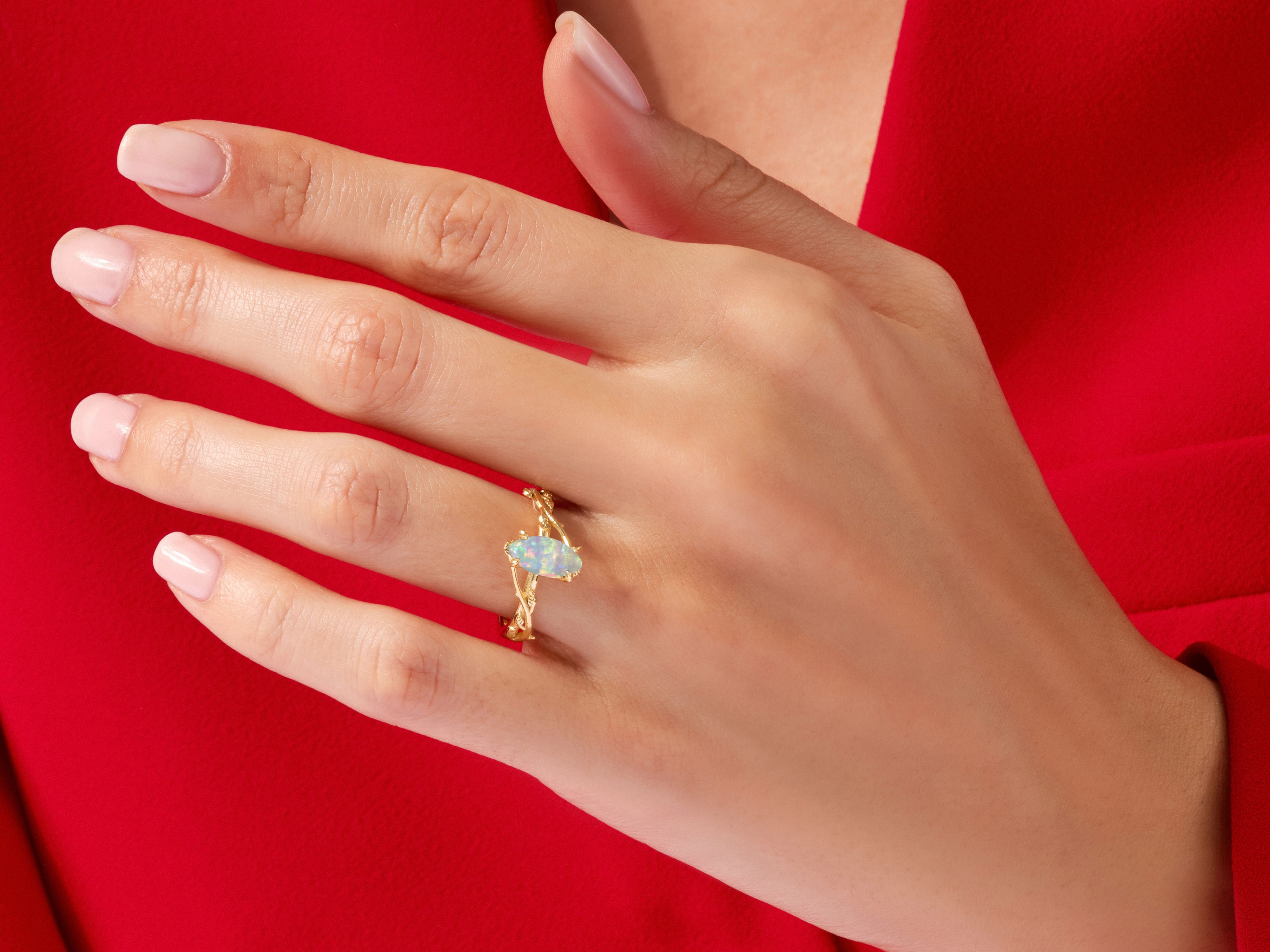 Gold opal ring on hand, elegant jewelry for women