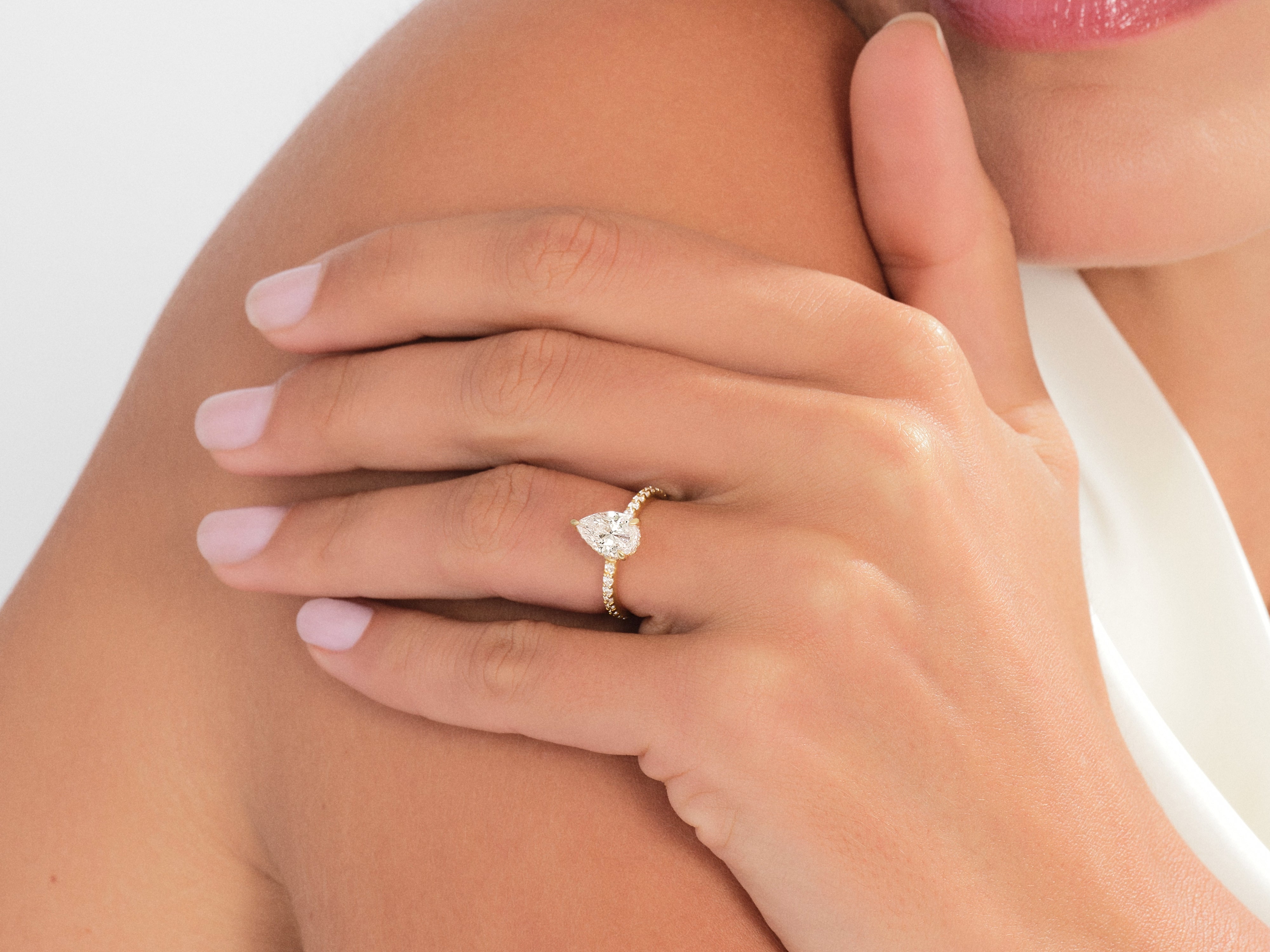 Sidestone Accent Pear Cut Moissanite Engagement Ring