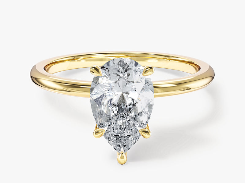 Gold ring with pear-shaped diamond engagement ring