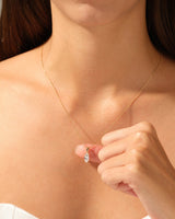 Gold necklace with diamond pendant on a woman's neck