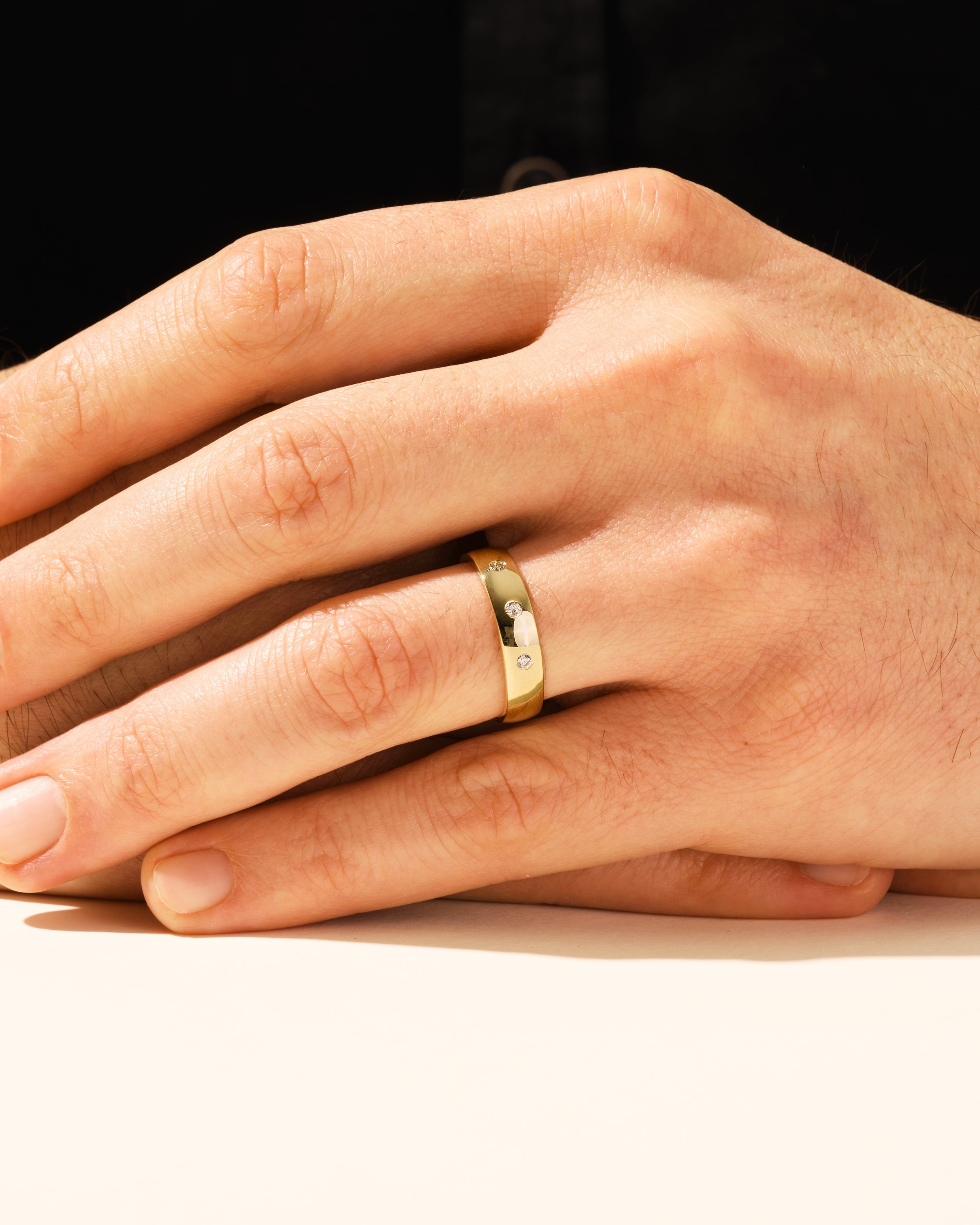 Gold diamond ring on a man's hand, jewelry product